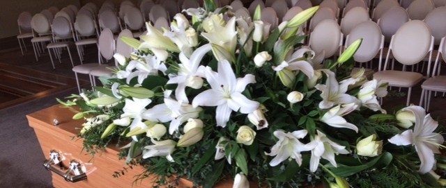 funeral flowers, lillies, classic white floral tribute,
